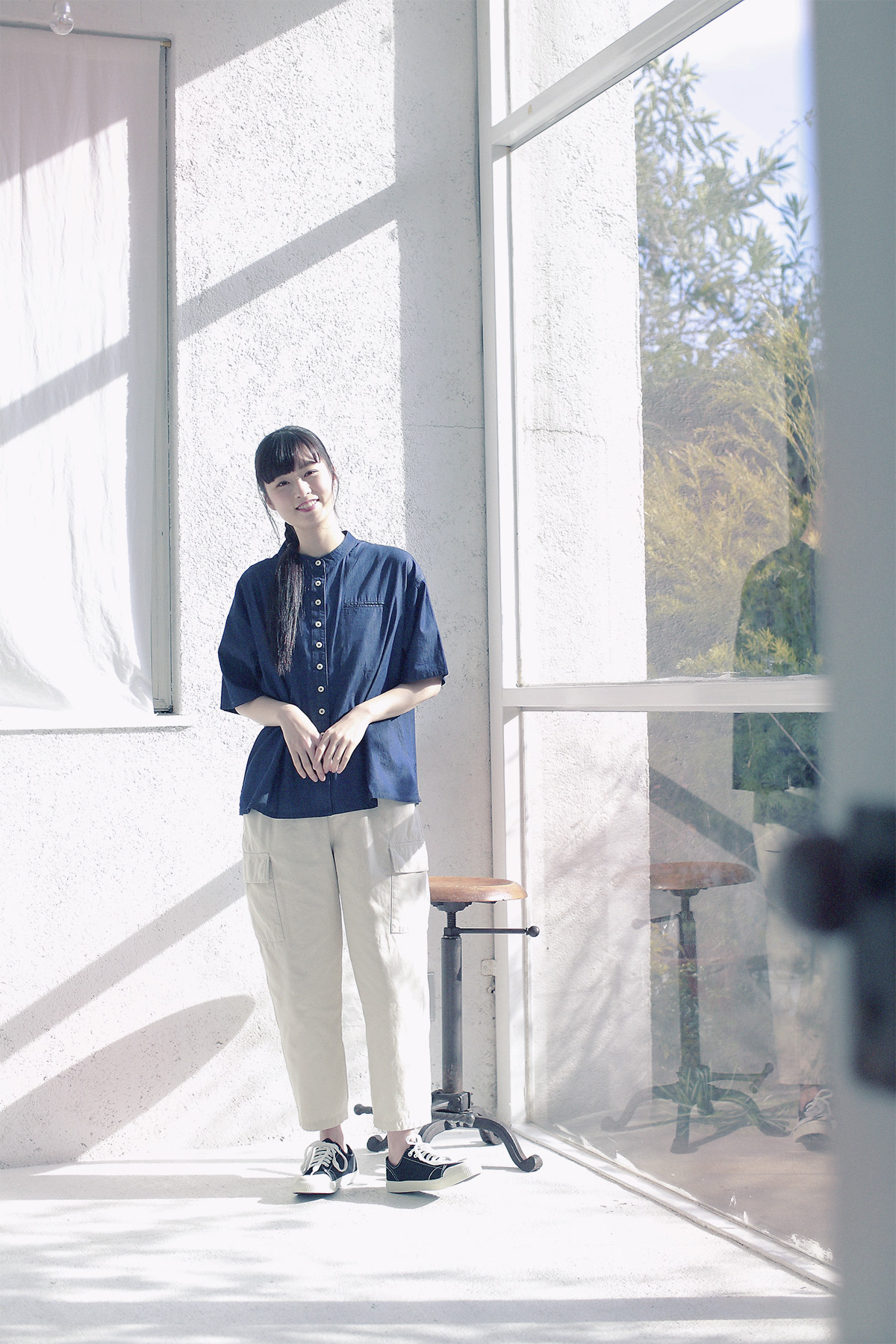 デニムシャツと帽子のコーディネートの女性モデル写真